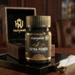 Hurrywell Extra Power Premium Shilajeet Capsules bottle placed on a luxury black platform with wooden premium packaging in the background, showcasing Ayurvedic vitality and wellness branding.