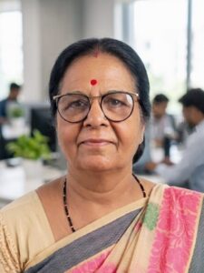 Dr. Asha Vaishnav Senior female Ayurveda professional wearing saree and glasses, smiling in an office environment at Hurrywell Ayurveda.